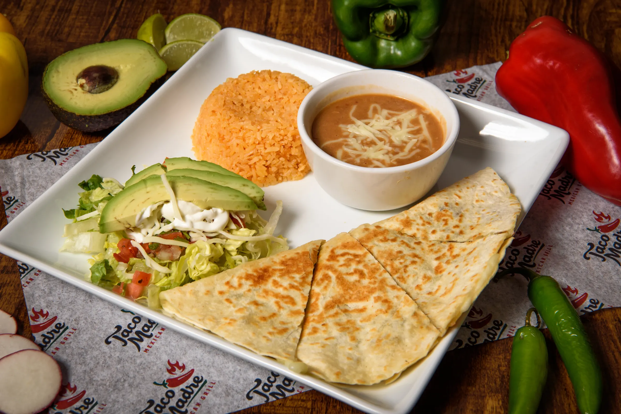 A quesadilla cut into wedges on a plate with salsa